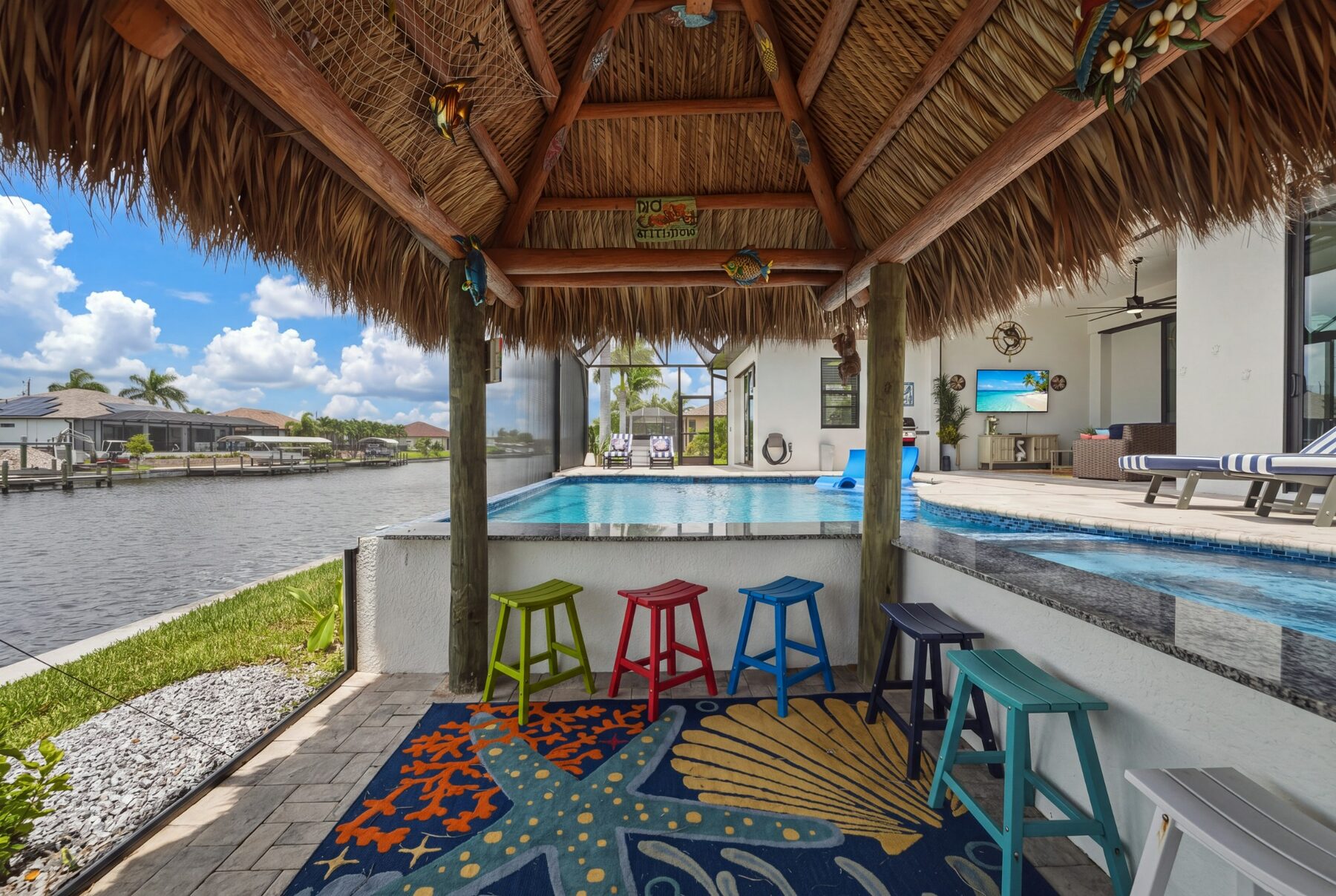 Swim-up tiki bar beside the pool and canal