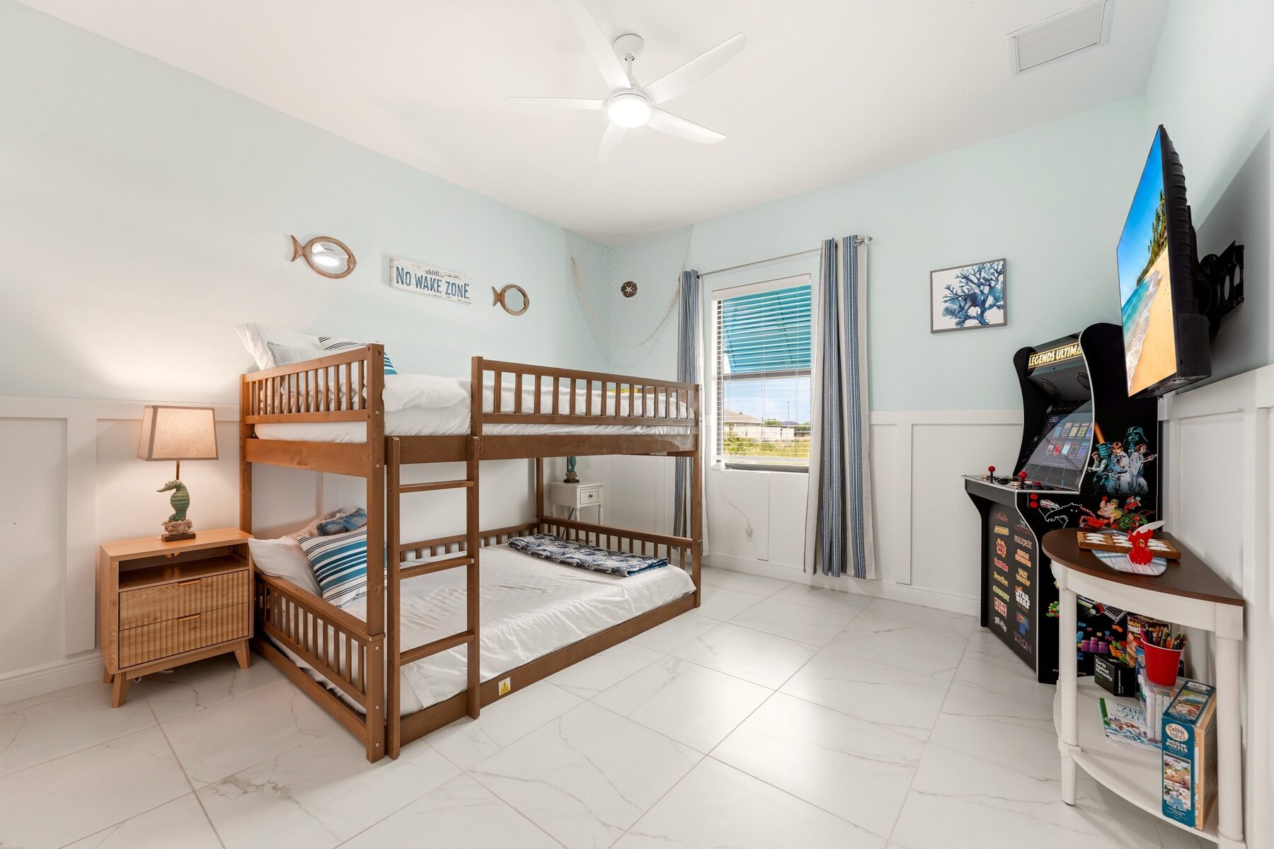 Family room with bunk beds, arcade game, television, and activities