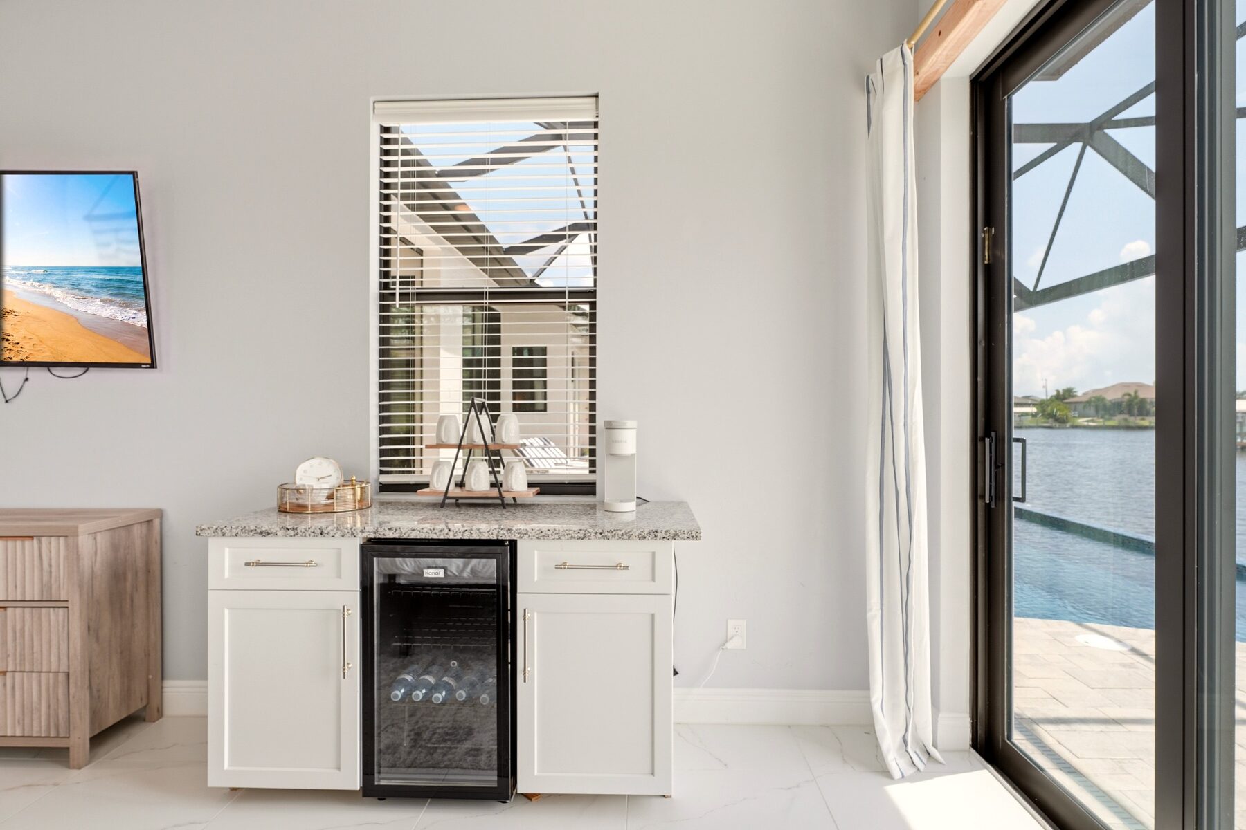 Guest beverage station beside sliding doors overlooking the canal