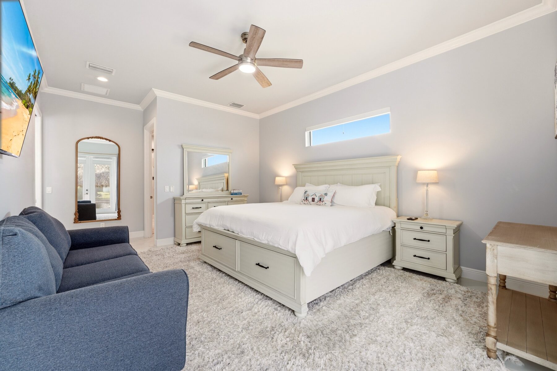 Spacious primary bedroom with king bed and seating area